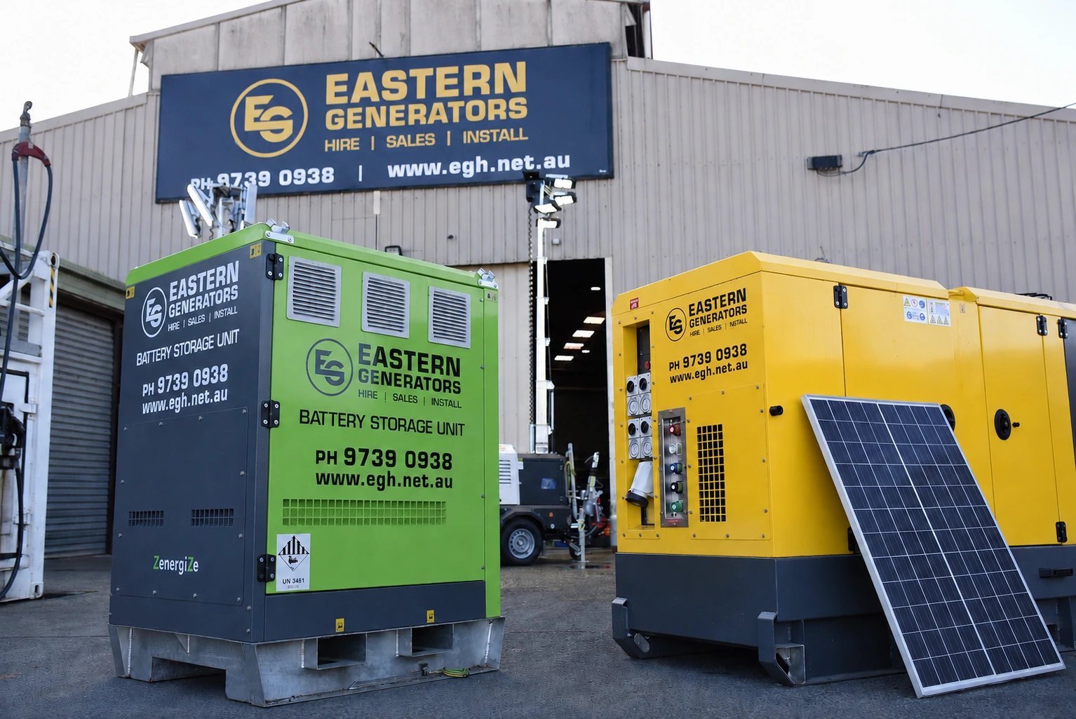 Eastern Generators green battery storage unit beside a diesel generator and solar panel