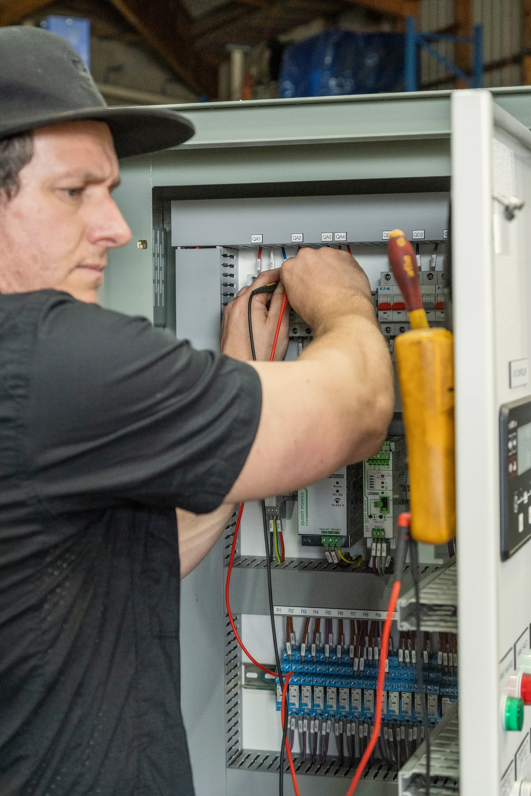 An Eastern Generators electrician working on an electrical panel