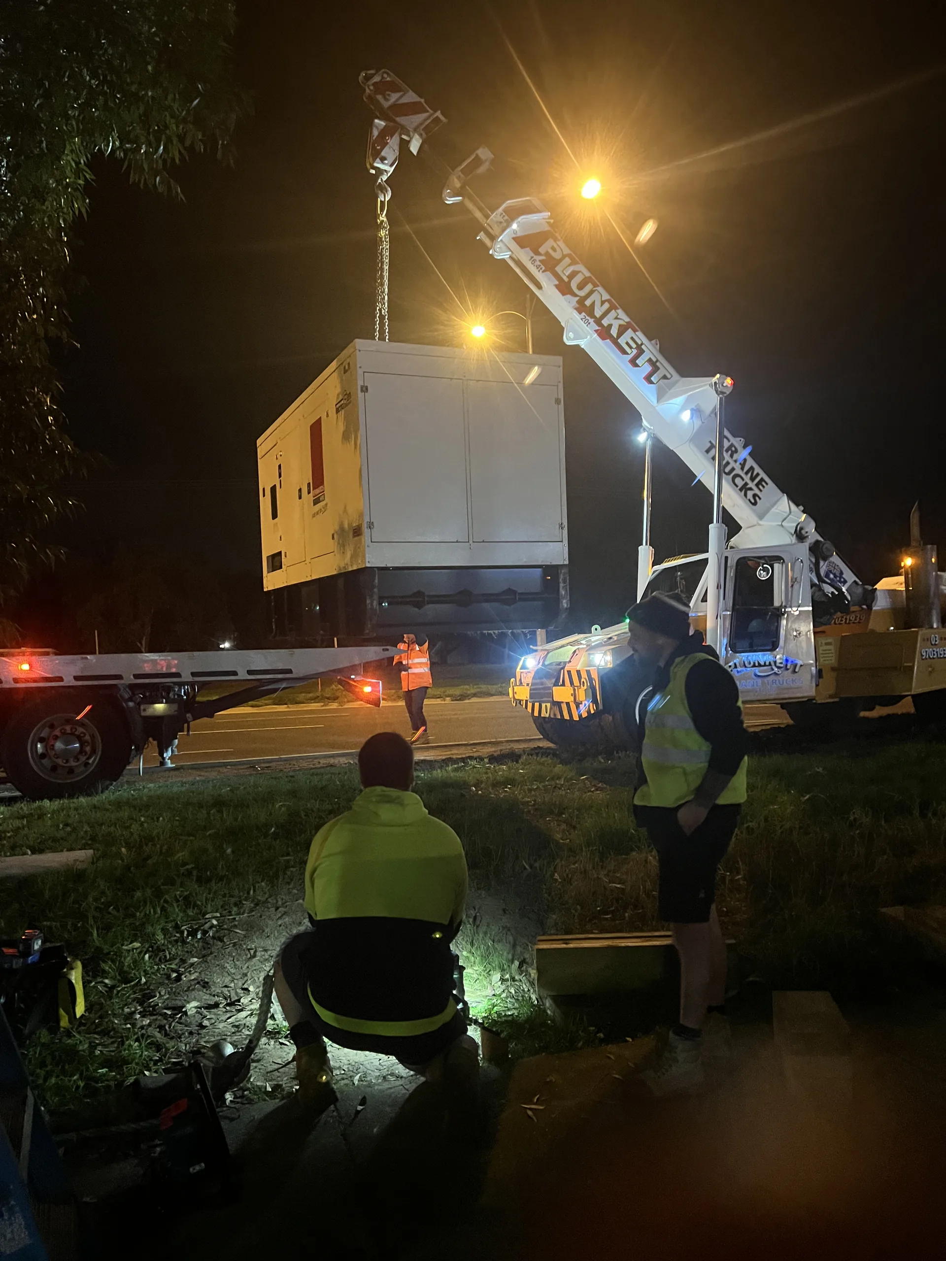 Eastern Generators crew working at night in reflective vests beside a truck