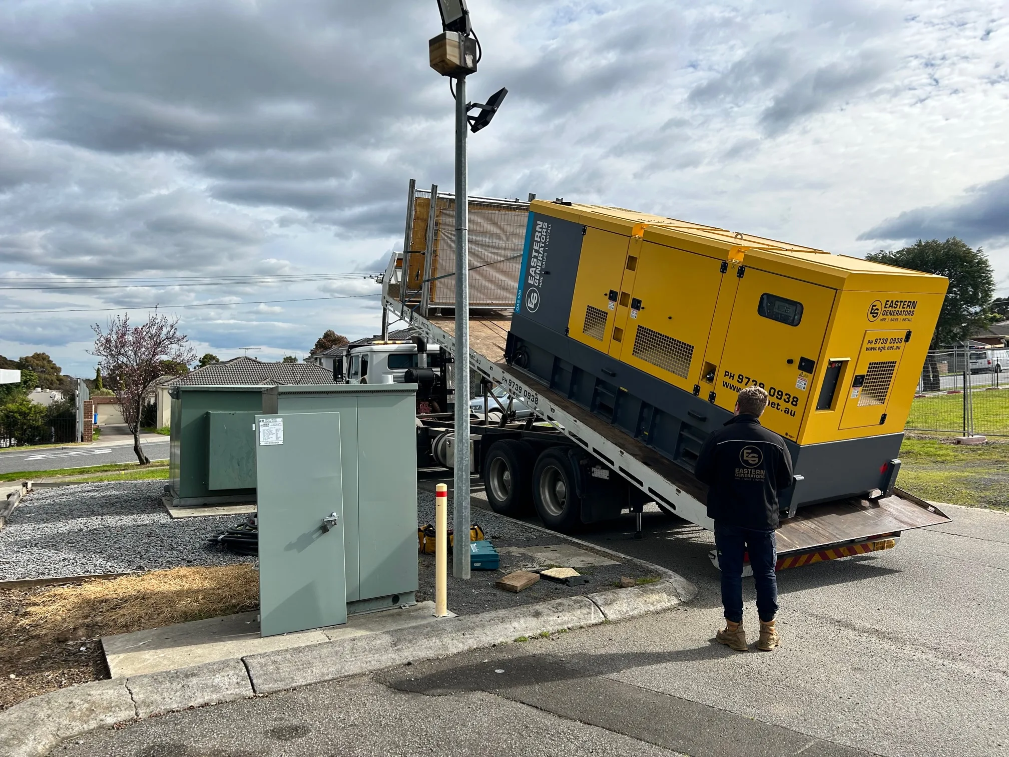 A hire generator placed beside a street supply pillar during a network shutdown