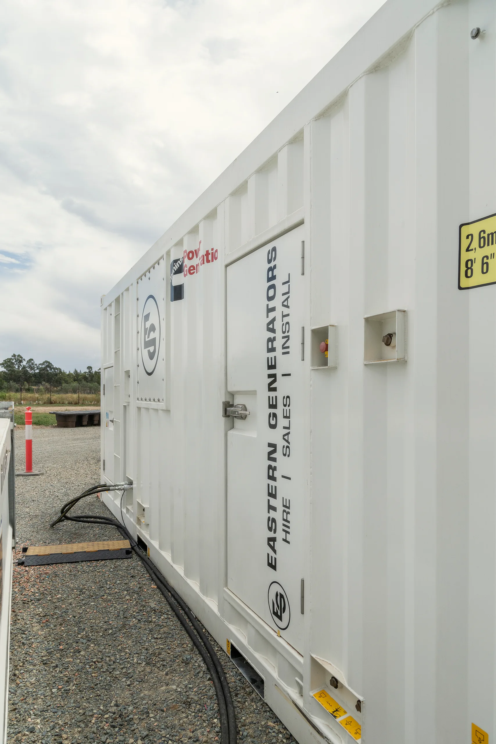A containerised Eastern Generators hire unit standing on site