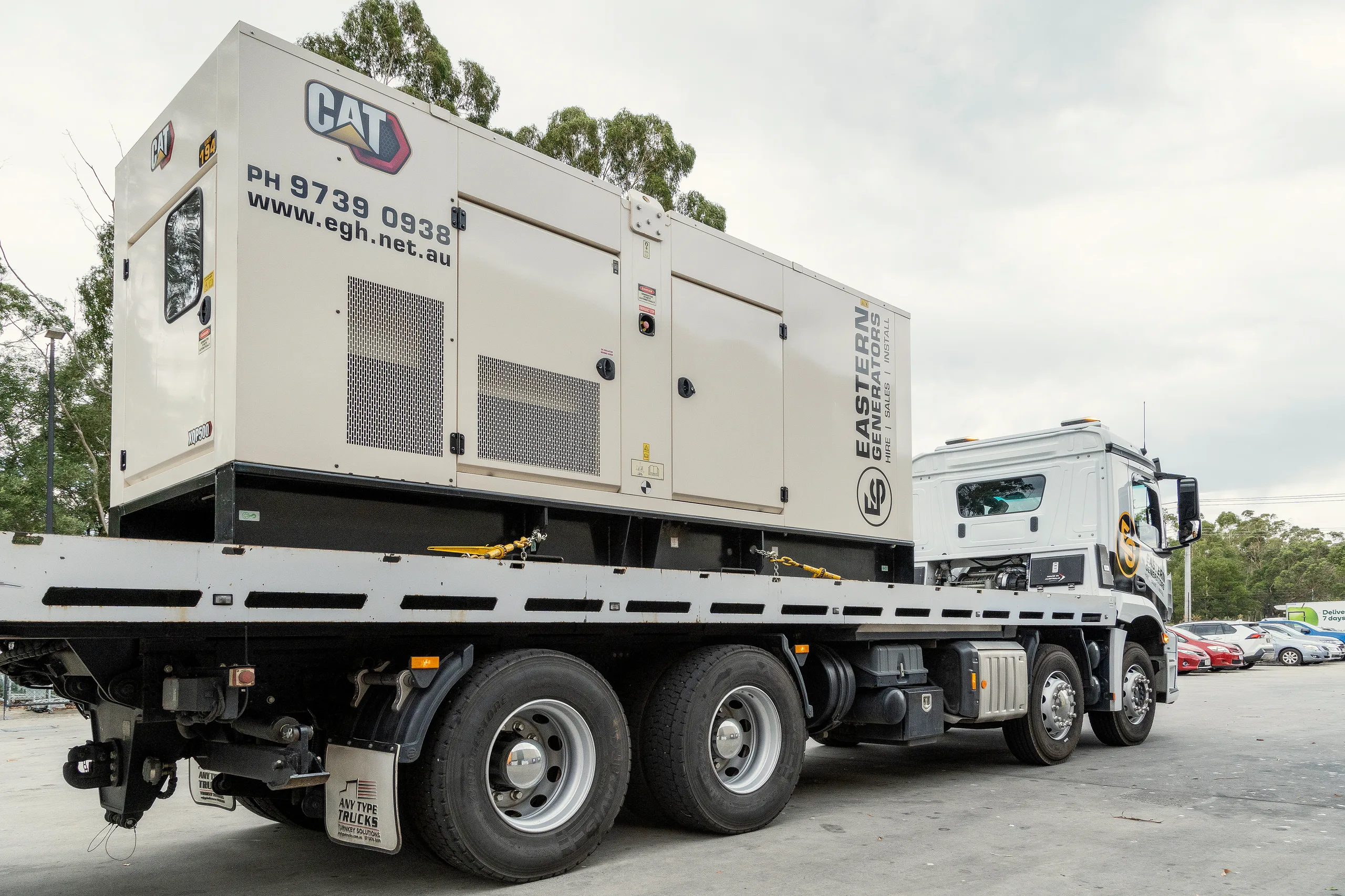 An Eastern Generators truck carrying a large generator on a flatbed to an emergency call-out