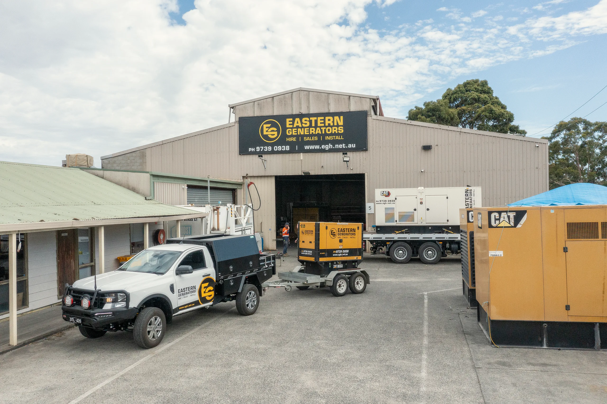 A small Eastern Generators hire set on a trailer behind a branded ute at the Kilsyth yard