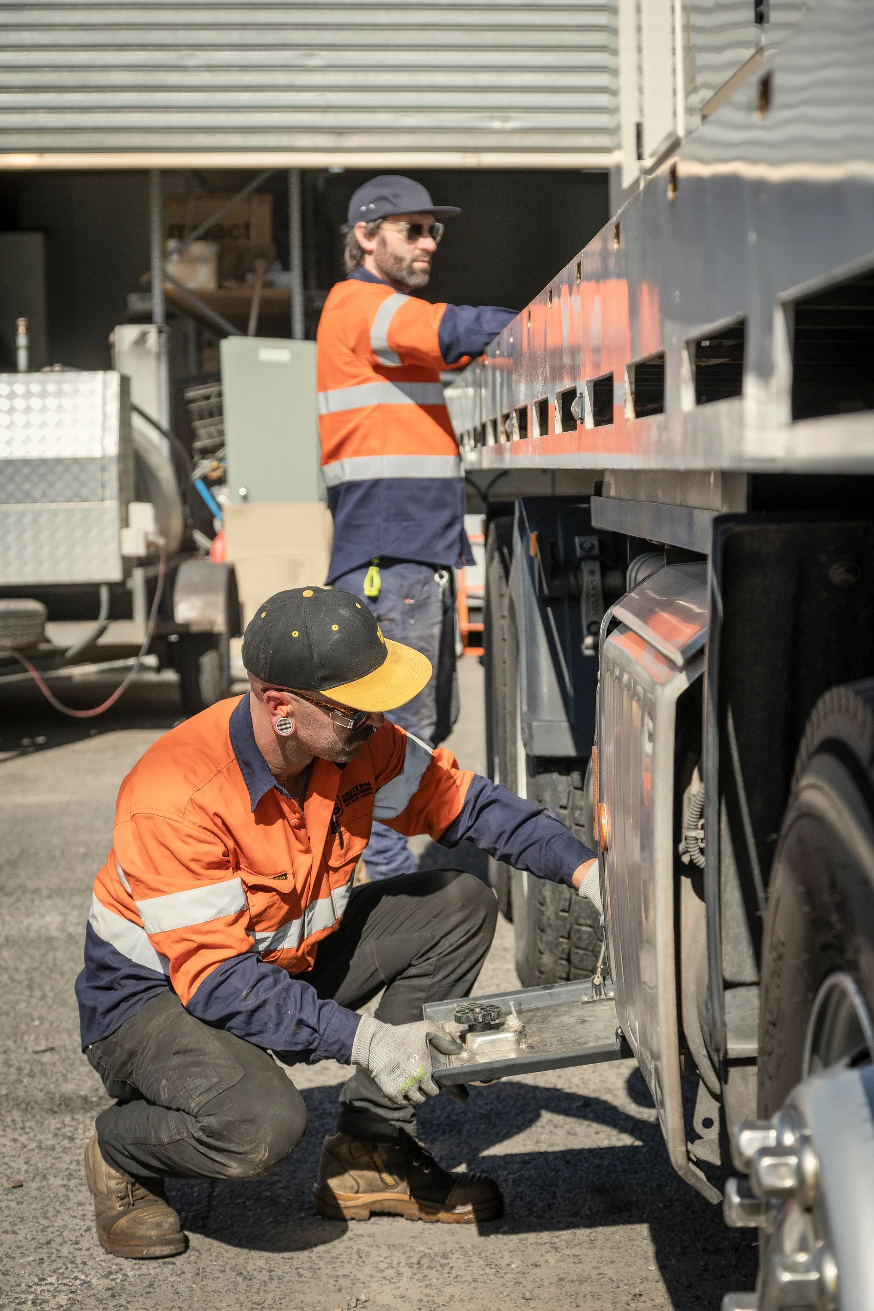 Eastern Generators crew working at the tail of a transport truck